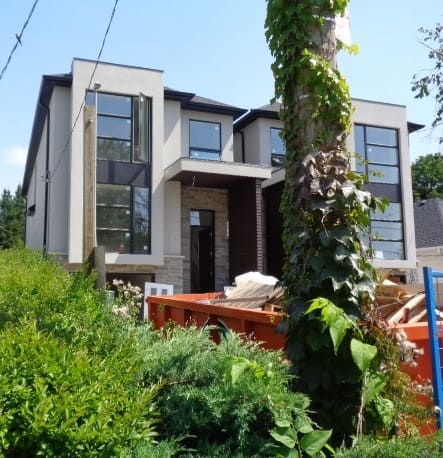 House Under Construction and Dumpster
